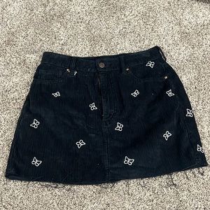 black skirt with white butterflies mini skirt with fraying at the bottom size 27